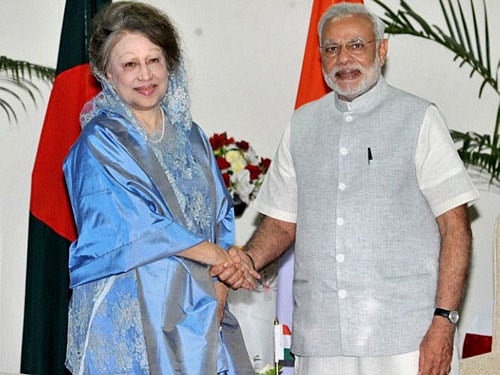 Prime Minister Narendra Modi shakes hands with the former Prime Minister of Bangladesh, Begum Khaleda Zia at a meeting in Dhaka, Bangladesh on Sunday. PTI Photo
