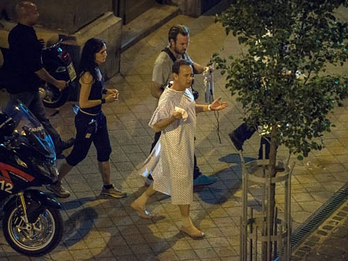 US actor Tom Hanks, right, playing the role of Harvard symbology expert, professor Robert Langdon walks on the set during shooting of their film 'Inferno' in Budapest, Hungary. AP photo