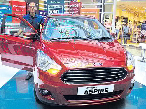 Ford India Marketing Vice President Raj Sarkar poses with the Ford Figo Aspire which was showcased in Bengaluru  on Saturday. DH Photo by B K Janardhan