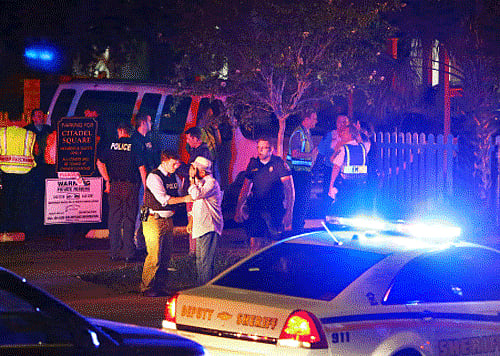 Police talk to a man outside the Emanuel AME Church following a shooting. AP Photo