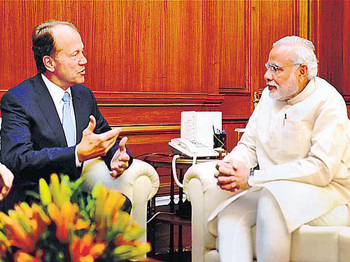 Prime Minister Narendra Modi (right) listens to Cisco Chairman John Chambers as they talk during a meeting in New Delhi on Thursday. PTI