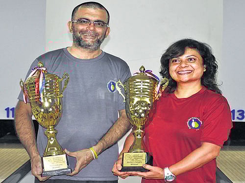 all smiles: Champions Vijay Punjabi (men's) and Judy Allan (women's) pose with their spoils on Friday.