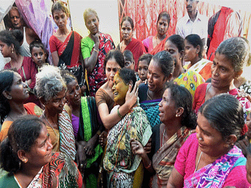 Family members of illicit liquor victims at the slum area of Malvani in Mumbai on Saturday. PTI Photo