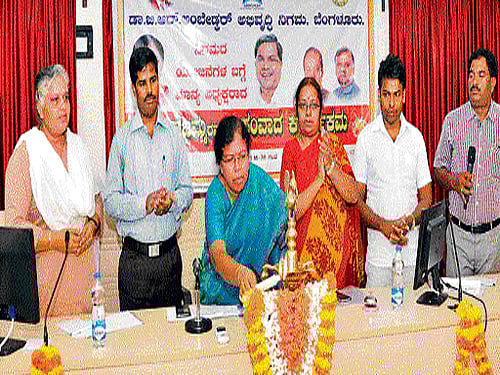 Dr B R Ambedkar Development Corporation chairperson Mallajamma lights a lamp to inaugurate an interaction programme in Manipal on Thursday. Additional Deputy Commissioner Kumar looks on. DH&#8200;photo