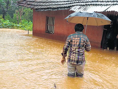 Knee-deep in water Water gushes into a house in Vittal of Puttur taluk, Dakshina Kannada district on Sunday.