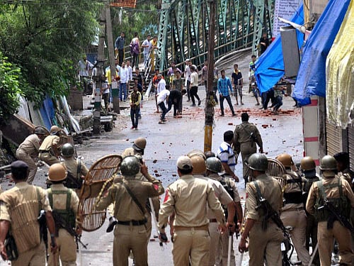 Protesters throw stones at police during a clash in Rajouri. PTI photo