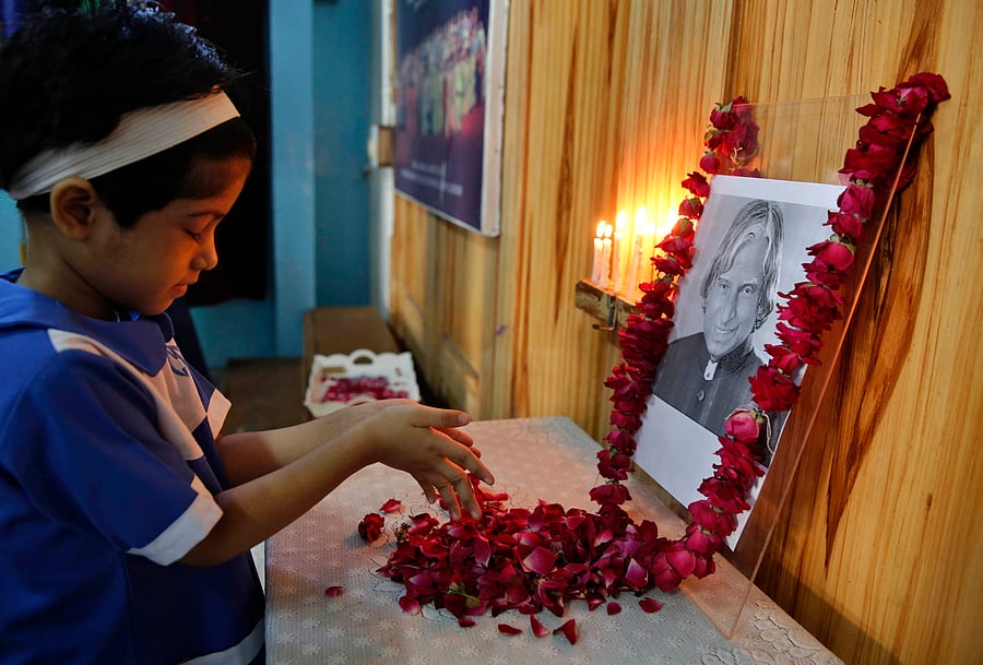 A student offers flowers to a portrait of former President A.P.J. Abdul Kalam at CMS School in Lucknow on Tuesday. AP