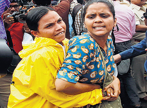 A policewoman detains a protestor who had gathered demanding that the move to hang 1993 Mumbai blasts convict Yakub Memon be stopped in Mumbai. AP