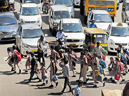 Students and parents are crossing the road in front of Sophia School