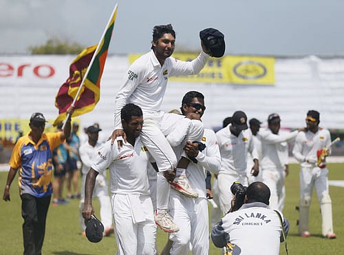 Sri Lanka's Sangakkara waves at his fans after they won their first test cricket match against India in Galle. Reuters photo