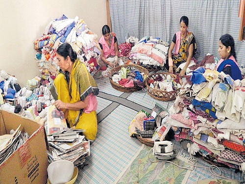 Women make sanitary pads from waste cloth at a processing unit of Goonj in Delhi.