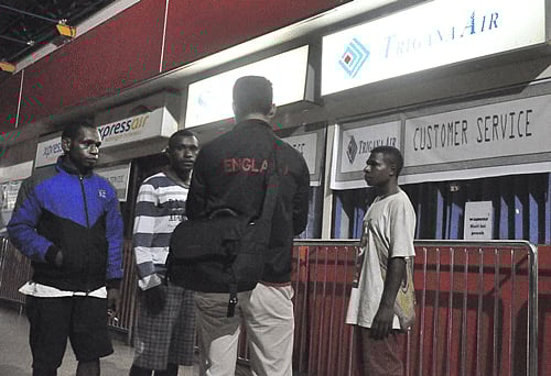 Family members of passengers on a missing Trigana Air flight seek information at Sentani Airport. Reuters