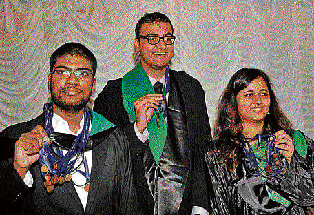 Gold medalists (from left) Shiva Santosh Kumar Y, Vansh Sharad Gupta and Mansi Sood share a happy moment at the 23rd annual convocation at the National Law School of India University campus on Sunday. dh photo