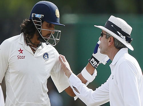 Umpire Llong speaks with India's batsmen India's Sharma after an argument between Sharma and Sri Lanka's bowler Prasad during the fourth day of their third and final test cricket match in Colombo. Reuters photo