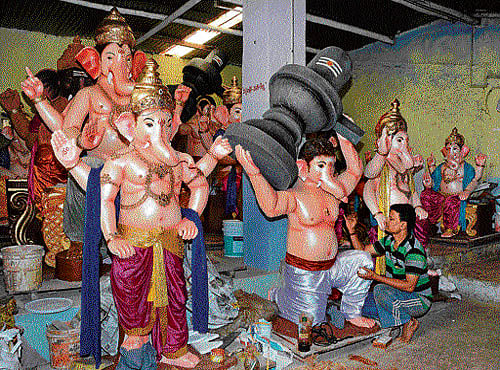 God of creativity Ganesha idols at artist Manjunath's workshop in Dharwad; (below) the Ganesha idol, made with bamboo, paper and cloth, in the Jaganmohan Palace in Mysuru. PHOTOS BY B M KEDARNATH AND AUTHOR