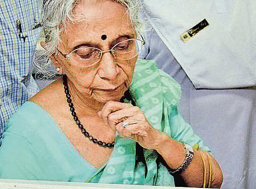 Netaji's niece Krishna Bose looks at the files on Friday. PTI