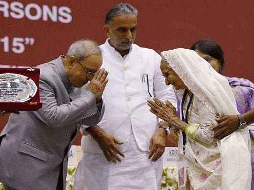 President Pranab Mukherjee Presenting the National Awards for Senior Citizens to Leelaben Chhabildas Gurjar during 'Vayoshreshtha Samman 2015' in New Delhi on Thursday. PTI Photo