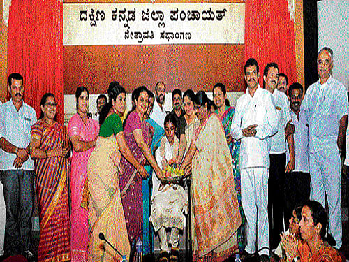Dakshina Kannada Zilla Panchayat president Asha Timmappa Gowda felicitates Rebeka, a bronze medalist in Special Olympics, during the 24th general body meeting at Nethravathi auditorium in Mangaluru on Thursday. Dh photo