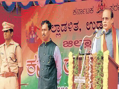 Minister Vinay Kumar Sorake speaks at Kannada Rajyotsava celebrations in Udupi on Sunday. DC Dr R Vishal, SP K Annamalai look on. DH photo