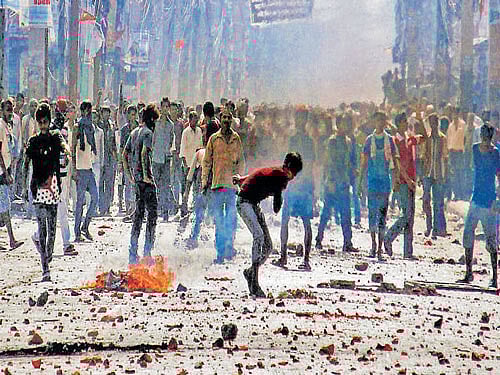 Madhesi protesters throw stones and bricks at Nepalese policemen in Birganj, a town on the Indo-Nepal border, on Monday. PTI