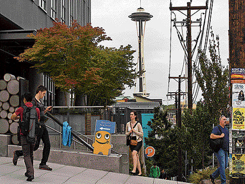A sign points new hires to the Arizona building on the Amazon campus in Seattle on July 20, 2015. NYT