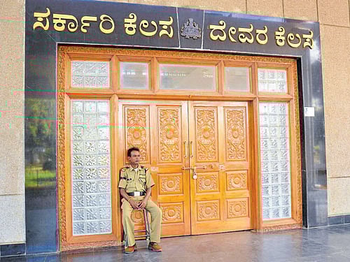 The deputy commissioner's (DC) office complex was locked as government officials and employees boycotted work, condemning the attack on the DC in Chamarajanagar on Tuesday. The security guard too was seen wearing a black band as a mark of protest. DH photo