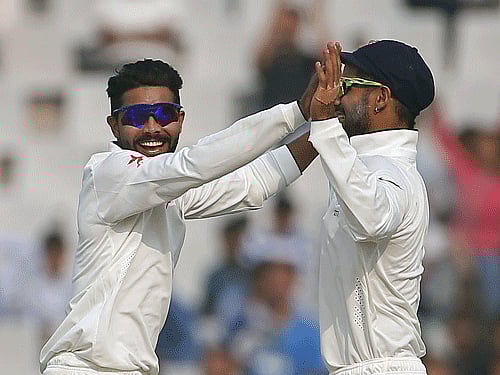 India's Ravindra Jadeja (L) celebrates with Shikhar Dhawan after dismissing South Africa's Dane Vilas (not pictured) during the third day of their first cricket test match, in Mohali. Reuters.