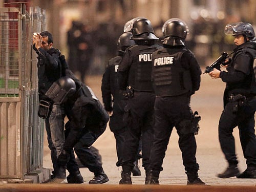 French spolice stop and search a local resident during an operation to catch Paris attack fugitives in Saint-Denis. Reuters
