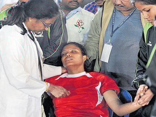 Assam's Bhanita Bora is being treated by a doctor after she collapsed during the game against BAKA on Friday. DH photo/ srikanta sharma r