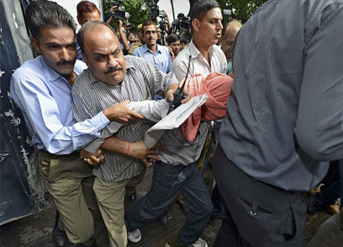 Policemen escort the convict (head covered with towel) to the juvenile court in New Delhi. REUTERS file photo