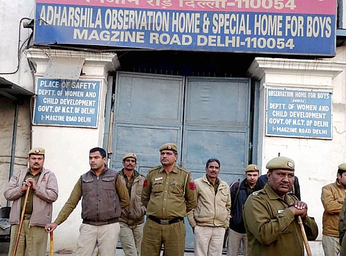 Police personnel outside the juvenile house during a protest against the release of juvenile delinquent in Nirbhaya Case, in New Delhi on Saturday. PTI Photo
