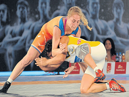 firm grip: Oksana Herhel of Haryana Hammers (top) and Sakshi Malik of Mumbai Garuda in action during their clash in the Pro Wrestling League at the Koramangala Indoor Stadium in Bengaluru on Thursday. DH Photo/ Srikanta Sharma R