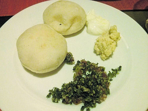 Pita bread with labneh, hummus and tabbouleh.