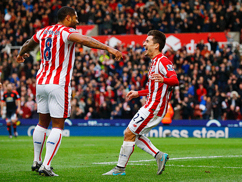 Bojan Krkic celebrates scoring the first goal for Stoke with Glen Johnson Reuters Photo.