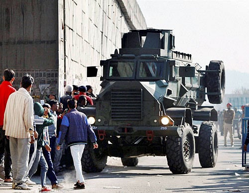 An armored vehicle moves near an Indian Air Force base that was attacked by militants in Pathankot, Punjab on Saturday. PTI Photo
