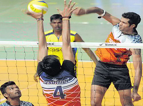 POWER-PACKED: Karnataka's Karthik A smashes past Jatin Singh of Rajasthan during their Group B match on Saturday. DH PHOTO