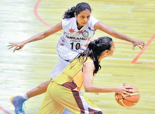 INTENSE ACTION: Karnataka's Lopamudra (in yellow) tries get past Tamil Nadu's Adirai M during their match inMysuru on Tuesday. DH PHOTO