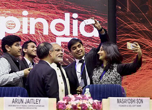 Prime Minister Narendra Modi poses for a selfie with the delegates during the launch of 'Startup India' action plan at Vigyan Bhawan in New Delhi on Saturday. PTI Photo