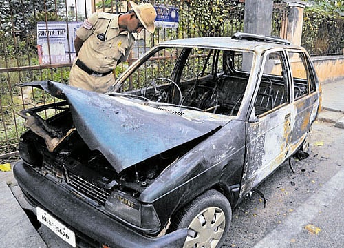 The remains of the car which caught fire near Cauvery Junction on Saturday. DH PHOTO