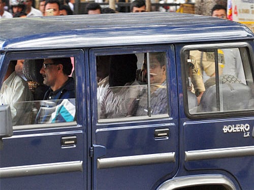 Three of the six terror suspects (in mask) being taken to a court in Bengaluru on Saturday. PTI