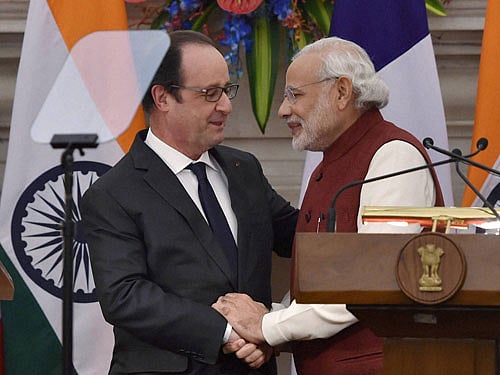 Prime Minister Narendra Modi and French President Francois Hollande greet each other after an MoU signing ceremony at Hyderabad House in New Delhi on Monday. PTI Photo