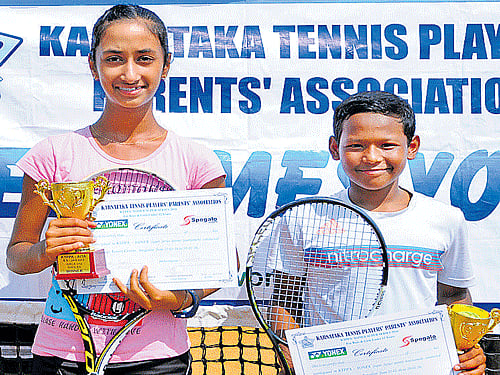 Winners Karnataka's Naisha Srivastav and Udit Gogoi of Assam with their spoils on Friday.