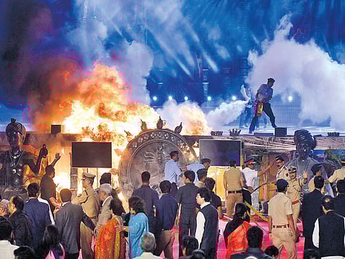 in flames: Officials try to douse a fire that broke out during an event held as part of the 'Make in India Week' in Mumbai on Sunday. DH Photo
