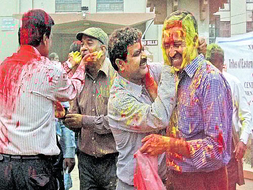 Staff of Viswa Bharati University celebrate with colours after President Pranab Mukherjee approved the sacking of  Vice-Chancellor Sushanta Dattagupta at Santiniketan in Birbhum district of West Bengal on Monday. PTI