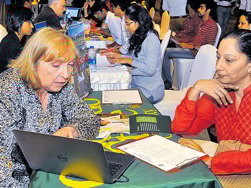 overseas opportunities: Students and parents participate in the 'Study Abroad Education Fair' organised in Bengaluru on Wednesday. dh Photo