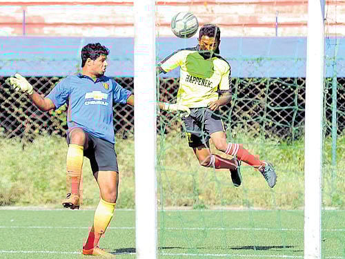 so close: SAI's Raj Kiran (right) attempts to score past RWF goalkeeper Arun during their Super Division clash at the Bangalore Football Stadium on Monday. Dh photo