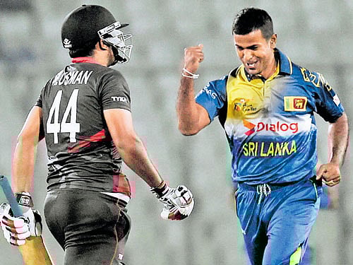 got you! Sri Lanka's Nuwan Kulasekara (right) celebrates the dismissal of UAE's Muhammad Usman. afp