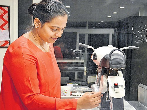 innovative Hima working on a Royal Enfield cake.