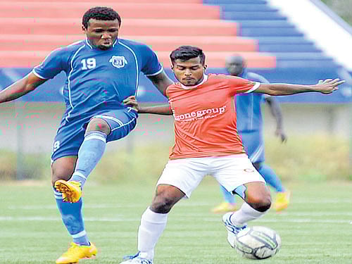 Keen Tussle: Keita (left) of Students Union FC battles for the ball with Ozone FC's Anup Thores Roy on Tuesday. DH Photo