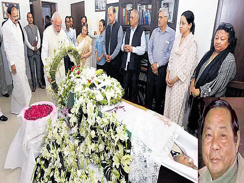 N-e icon: Prime Minister Narendra Modi pays his last respects to the mortal remains of former Lok Sabha Speaker P A Sangma (inset) at his residence in New Delhi on Friday. Union minister Venkaiah Naidu looks on. pti